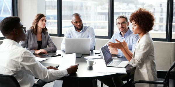 Meeting taking place around an office table